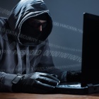 Is Your CMS Install Up To Date? Computer hacker stealing data from a laptop concept for network security, identity theft and compute