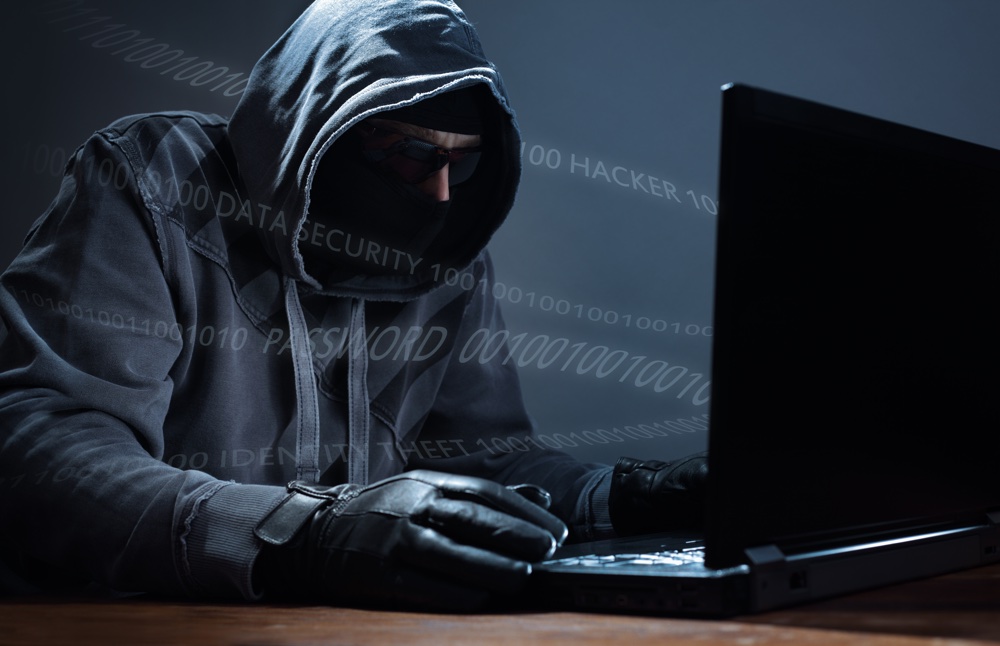 Computer hacker stealing data from a laptop concept for network security, identity theft and compute