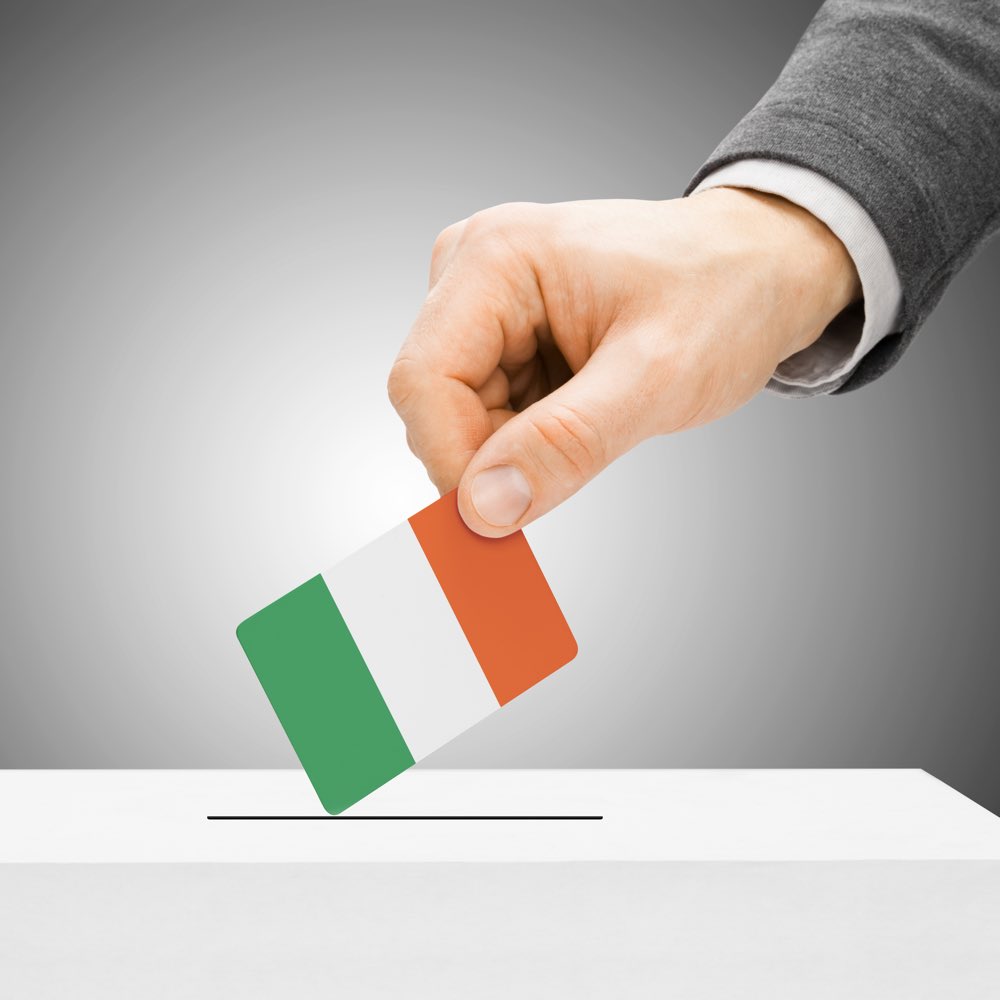 Voting concept - Male inserting flag into ballot box - Ireland