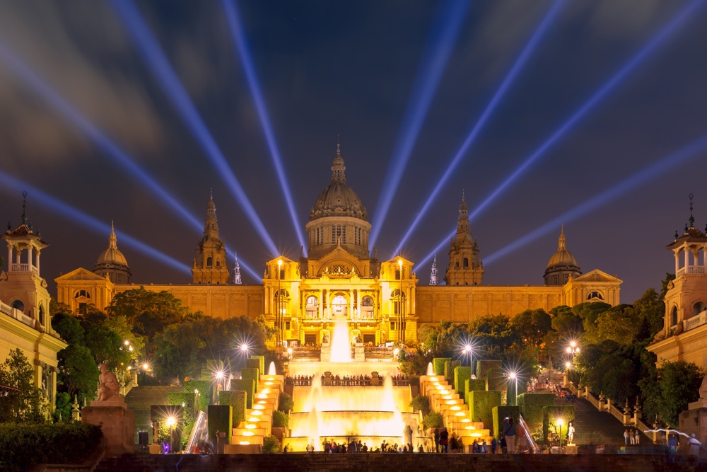 Famous light show and magic fountains in front of the National Art Museum at Placa Espanya in Barcelona at night, Catalonia, Spain