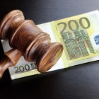 So Your Short IE Domain Application Is Going To Auction .. .. Concept For Corruption Bankruptcy Bail Crime Bribing Fraud Auction Bidding. Judges or Auctioneer Gavel Soundboard And Euro Cash On The Rough Black Wooden Textured Table Background.
