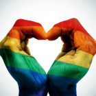 Blacknight’s LGBT Weekend at The Outing in Lisdoonvarna man hands patterned as the rainbow flag forming a heart, symbolizing gay love