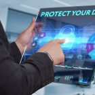 Protecting Your Customers’ Data Can Save Your Reputation And Money Business Technology Internet and network concept. Business man working on the tablet of the future select on the virtual display: Protect your data
