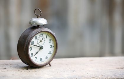 IE Liberalisation Coming March 21st! Get the Domain of Your Dreams Quickly and Easily Vintage metal analog alarm clock with Arabic numbers and windup mechanism sitting on a wooden bench with retro background. Time is now time is money old times concept.