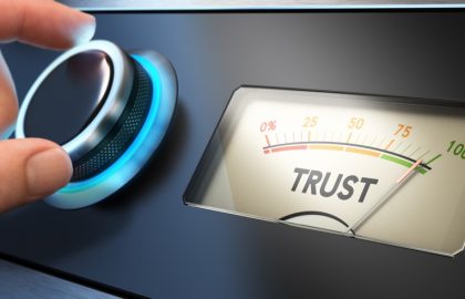 Maintaining Trust, Respecting Privacy and Due Process Hand turning a knob up to the maximum Concept image for illustration of trust in business.