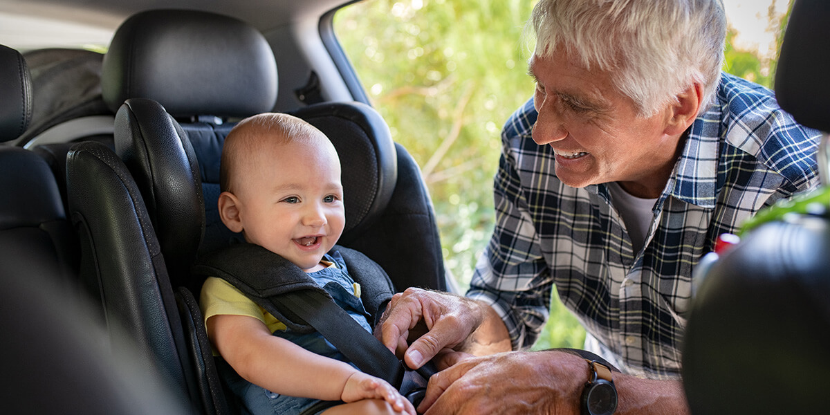 A grandfather secures a baby in his car seat. What are the 'rules of the road' for online safety?