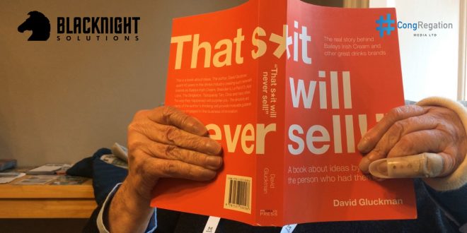 David Gluckman shows the cover of his book "That S*it will Never Sell" at Congregation in 2017