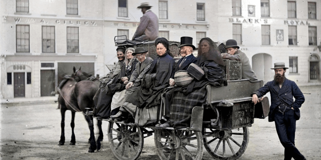 Royal Mail 979 Day Car This is a mail car near Black's Royal Hotel, Eyre Square in Galway city, loaded up with a fabulous mix of passengers. Eyre Square, Galway Date: Circa 1880? NLI Ref.: L_CAB_00895 Source: https://buff.ly/31bINIu @NLIreland #DeOldify @ColorizeImages #Photoshop