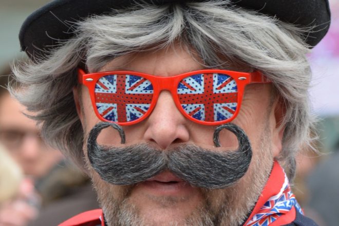 Man with union jack glasses, hat and more